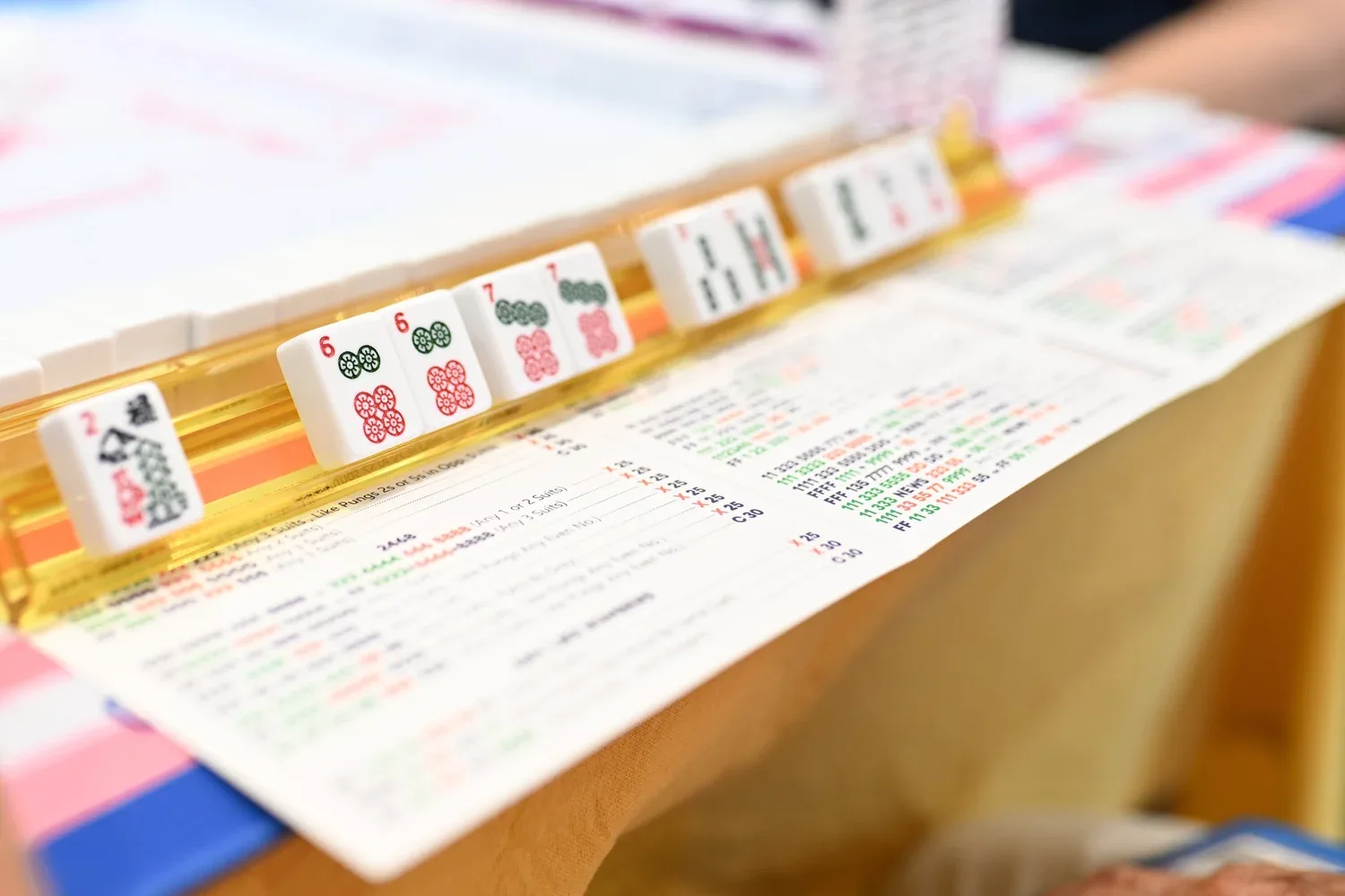 Mahjong tiles lined up alongside an American mahjong card
