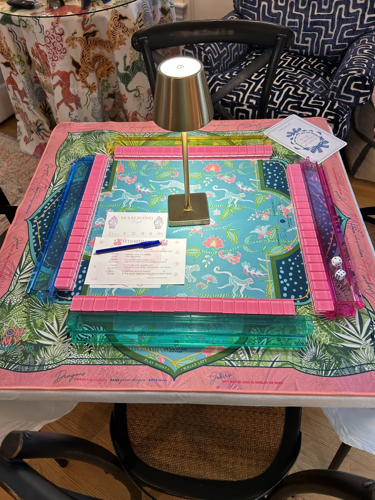 Colorful mahjong tiles, racks, and a patterned game mat