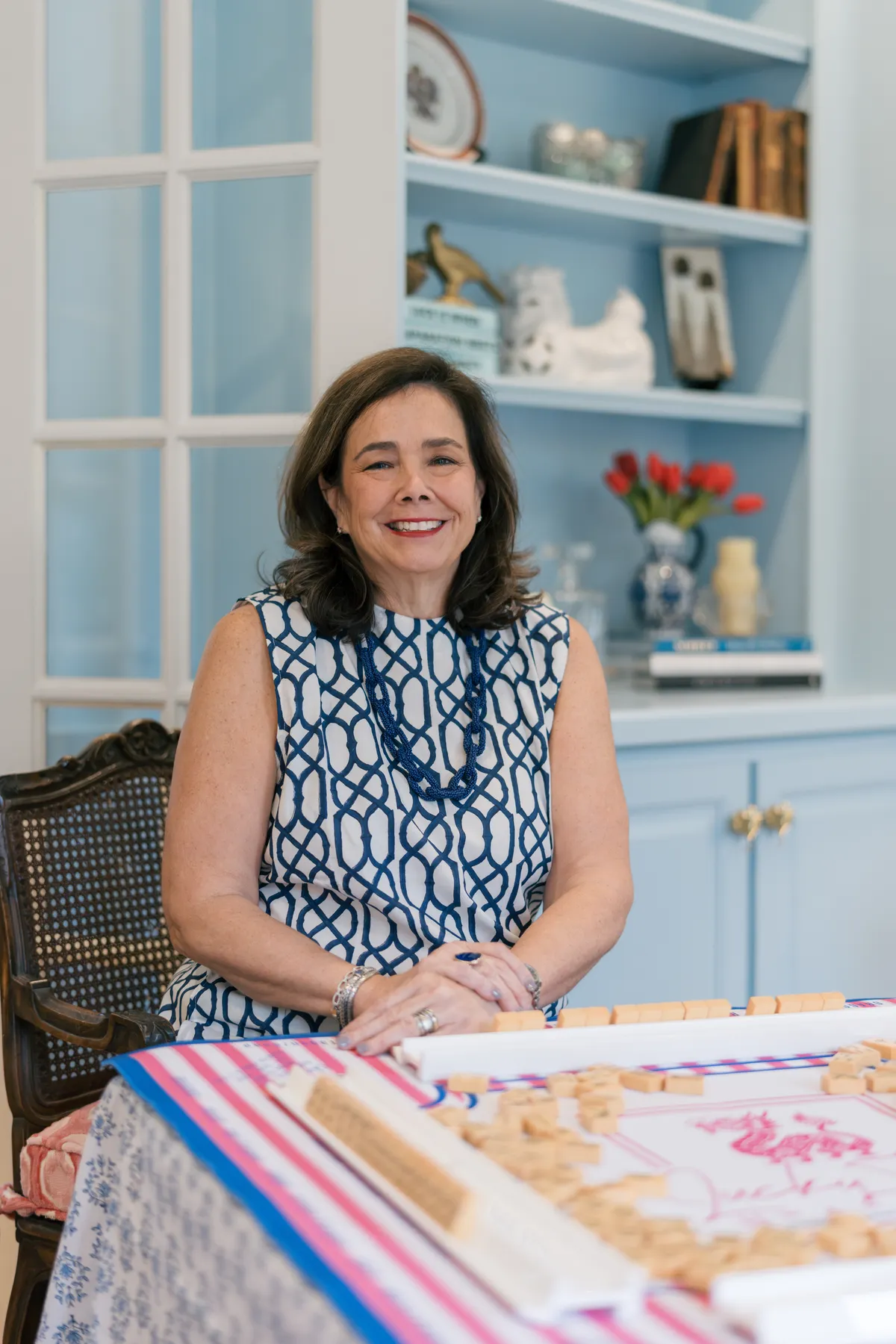 Lauren Price, founder of Lucky Tiles Mahjong, smiling at a mahjong table in The Atelier